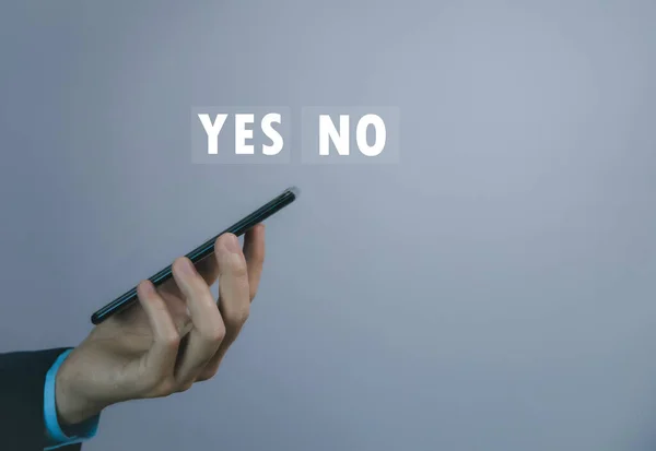Businessman using smartphone to show yes or no. Concept of voting decision. think right or wrong Business options for difficult situations true and false symbols