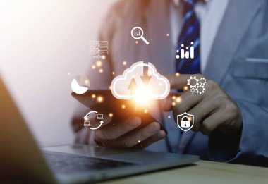 Businessman holding a light bulb showing a diagram of Cloud computing information technology icon. Concept of big data digital connection on communication networks. storage security internet service