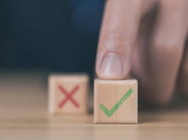 wooden block showing right and wrong sign decision concept, vote and think yes or no Business options for difficult situations true and false symbol