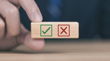 wooden block showing right and wrong sign decision concept, vote and think yes or no Business options for difficult situations true and false symbol