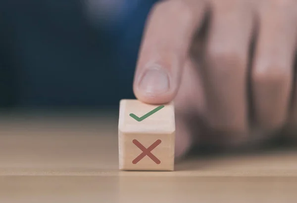 Wooden blocks show the right check marks and are wrong. concepts decisions, votes, and thinking yes or no. Business options for difficult situations true and false symbols