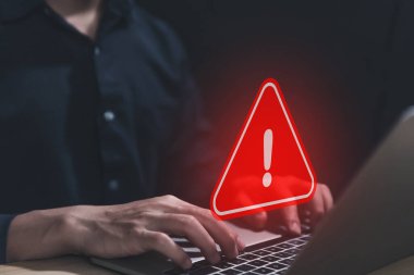 Businessman using laptop showing warning triangle and exclamation sign icon Warning of dangerous problems Server error. Virus. Maintenance concept. caution internet technology network security