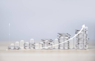 İşadamı hisse senedi finansal endekslerini analiz eder ve hesaplar. Bozuk para istiflemek büyüyor. Banka hesabında para biriktirme ve iş yatırımlarından elde edilen karı maksimuma çıkarmak için fonlara yatırım yapma fikirleri