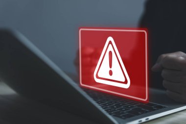 Businessman using laptop showing warning triangle and exclamation sign icon Warning of dangerous problems Server error. Virus. Maintenance concept. caution internet technology network security