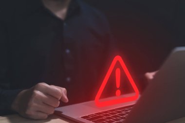 Businessman using laptop showing warning triangle and exclamation sign icon Warning of dangerous problems Server error. Virus. Maintenance concept. caution internet technology network security