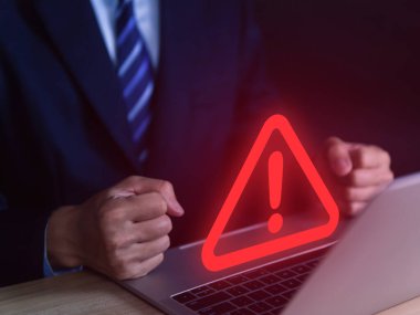 Businessman using laptop showing warning triangle and exclamation sign icon Warning of dangerous problems Server error. Virus. Maintenance concept. caution internet technology network security