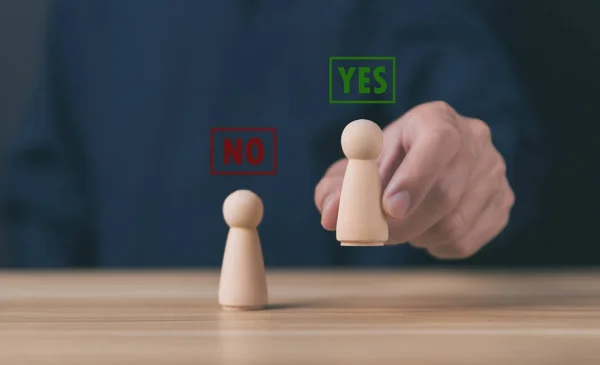 block people showing a yes or no letter. The concept of decision-making, pronunciation, and right and wrong thinking. Business options for difficult situations true and false symbol. select letter yes