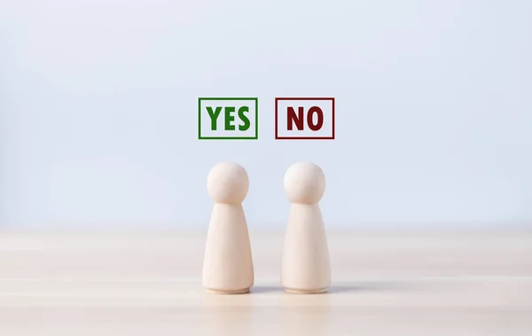 A wooden block people showing a yes or no letter. The concept of decision-making, pronunciation, and right and wrong thinking. Business options for difficult situations true and false symbol