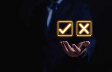 Businessman hand showing right and wrong symbol The idea is to decide to vote. Think yes or no decisions, and business options for difficult situations. true and false symbols agreeing