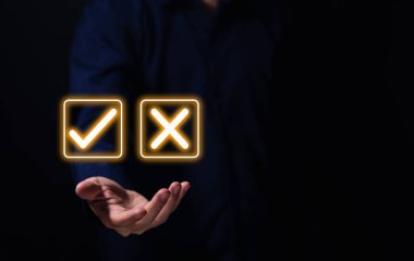 Businessman hand showing right and wrong symbol The idea is to decide to vote. Think yes or no decisions, and business options for difficult situations. true and false symbols agreeing