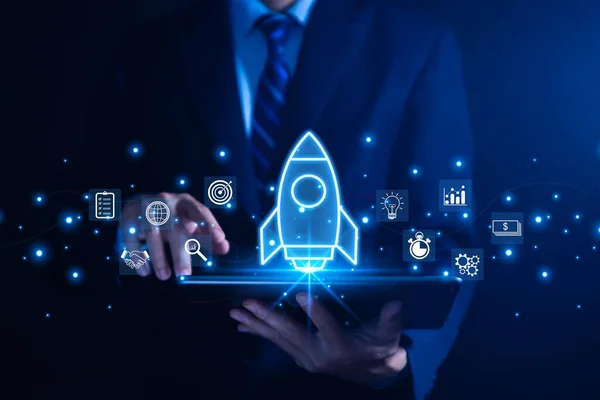 stock image The hand shows a rocket. Concept of Startup Business, Entrepreneurship Idea, and Online Digital Business. network connection on the interface Marketing, Technology, and Success