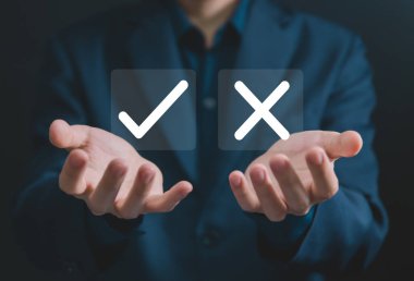 Businessman hand showing right and wrong symbol The idea is to decide to vote. Think yes or no decisions, and business options for difficult situations. true and false symbols agreeing