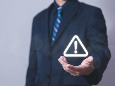 Businessman using laptop showing warning triangle and exclamation sign icon Warning of dangerous problems Server error. Virus. Maintenance concept. caution internet technology network security