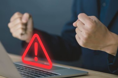 Businessman using laptop showing warning triangle and exclamation sign icon Warning of dangerous problems Server error. Virus. Maintenance concept. caution internet technology network security