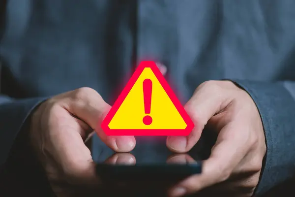Businessman using laptop showing warning triangle and exclamation sign icon Warning of dangerous problems Server error. Virus. Maintenance concept. caution internet technology network security
