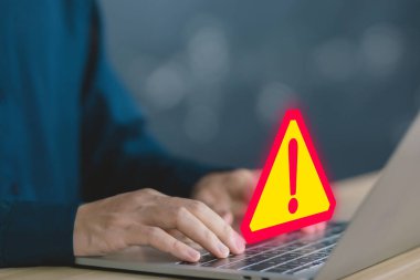 Businessman using laptop showing warning triangle and exclamation sign icon Warning of dangerous problems Server error. Virus. Maintenance concept. caution internet technology network security