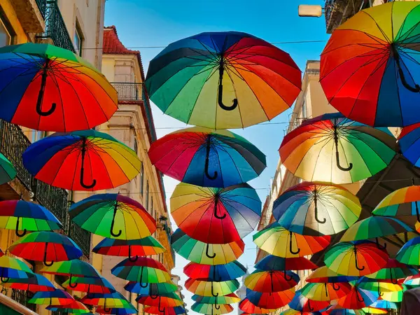 Multicolored umbrellas Rainbow colored umbrellas hang along the street in Lisbon, Portugal. LGBTQ community concept.