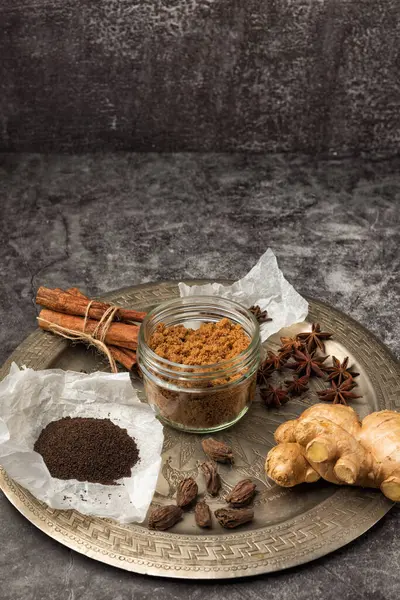 Hint Masala Çayı 'na baharat. Yiyecek ya da bitki çayı karışımı. Tarçın çubukları, yeşil kakule tohumları ve gri dokuda anason..