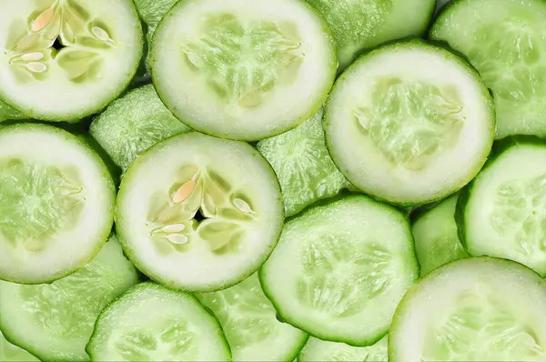 Cucumber slices background image. Cucumber pieces.