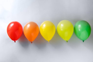 Selection of colorful balloons on grey background, top view