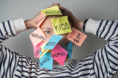 Mental load concept - female has post-it notes with social responcibilities on her face. High quality photo clipart