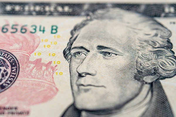 Portrait of Alexander Hamilton on a ten dollar bill close-up.