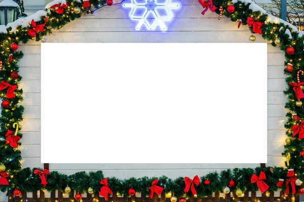 Christmas or New Year's market house in a European city decorated with toy balls and garlands at night with copy space for a text. Mock up.