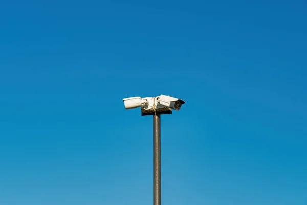 Security control camera or CCTV on blue sky background.
