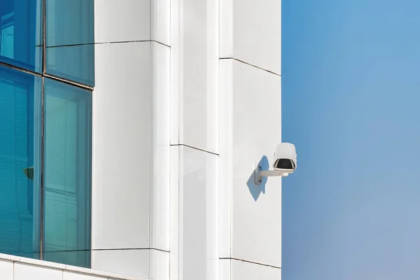Security control camera or CCTV on a white wall.
