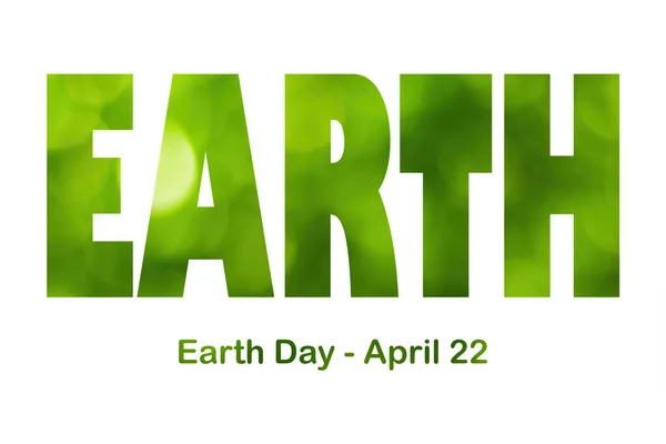 Lettering Earth Day April 22 on the green bokeh background. Earth day concept, protection of the planet from pollution, improvement of environmental ecology and nature conservation.