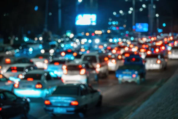 Blurred car traffic lights at night city. Traffic jam in evening rush hour.