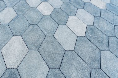 The texture of a monotonous tiled pavement with perspective.