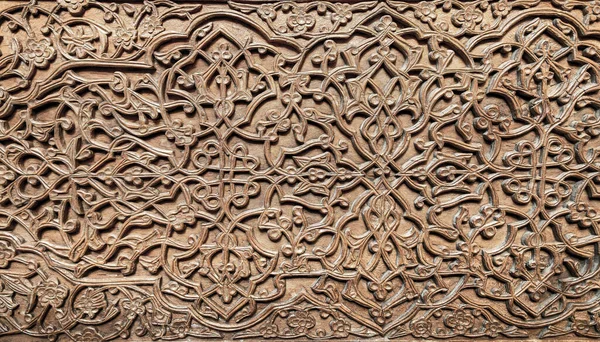 stock image Fragment of an ancient carved wooden door. Ornate background.