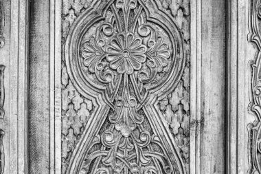 Carved antique wooden doors with patterns and mosaics.