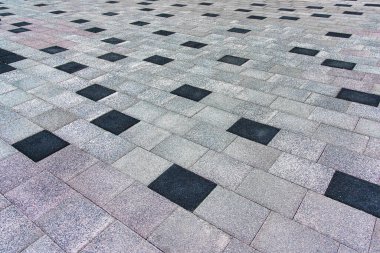 The texture of a monotonous tiled pavement with perspective.