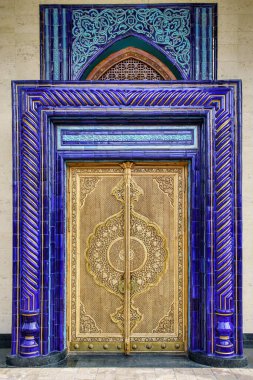 Carved antique wooden doors with patterns and mosaics.