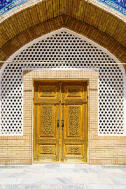 Carved antique wooden doors with patterns and mosaics.