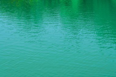 The texture of the waves of turquoise color of fast-flowing water in the river. Abstract nature background.