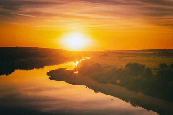 stock image Sunrise or sunset on a lake or river with dramatic cloudy sky reflection in the water in summertime. Aesthetics of vintage film.