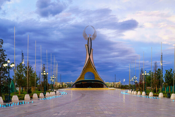 UZBEKISTAN, TASHKENT - AUGUST 15, 2023: Monument of Independence in the form of a stele with a Humo bird on a twilight in the New Uzbekistan park in summertime.