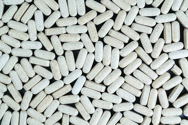 stock image Texture of a pile of oval yellow medical pills or dietary supplements.