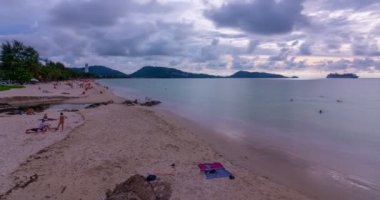 Phuket thailand Timelapse people relax on the patong beach Phuket thailand in summer travel season Tourist are enjoying activities on the beach during the holidays Phuket patong beach at Sunset time