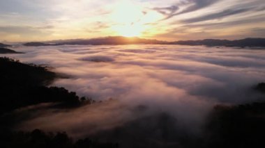 High angle view drone view of fog in rainy season over mountains,Beautiful sunrise sky clouds for create nature video scene. 4K High quality footage