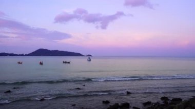 Uzun kuyruklu balıkçı tekneleri denizde güneş doğarken gökyüzünde bulutlarla Patong körfezinin üzerinde sabah Phuket Tayland 'da, yaz mevsiminde güzel deniz.