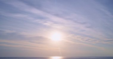 Deniz manzarası üzerinde gün batımının hızlandırılması, doğanın inanılmaz ışığı gökyüzü bulutları ve bulutlar yuvarlanıyor, renkli gün batımı ya da gün doğumunda dramatik bulutlar altın saat içinde