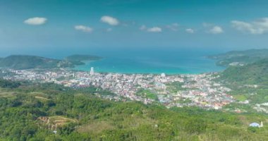 Aerial view Drone High angle view, Hyperlapse footage of patong city with high mountain in the foreground,Patong bay Phuket Thailand Beautiful nature background,High quality timelapse clouds over sea