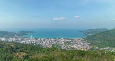 Aerial view Drone High angle view, Hyperlapse footage of patong city with high mountain in the foreground,Patong bay Phuket Thailand Beautiful nature background,High quality timelapse clouds over sea