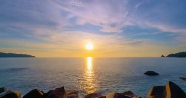 Time lapse of Majestic sunset light sky over sea landscape,Amazing light of nature cloudscape sky and Clouds moving away rolling 4K High quality timelapse,Colorful sunset or sunrise light sky