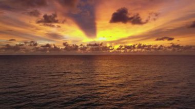 Sunset over ocean sandy beach, Aerial view tilt up shot amazing sunset or sunrise light
