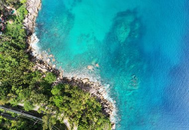 Aerial view of curve road along the seashore at Phuket Thailand, Beautiful seacoast and open sea in summer season,Nature recovered Environment and Travel background